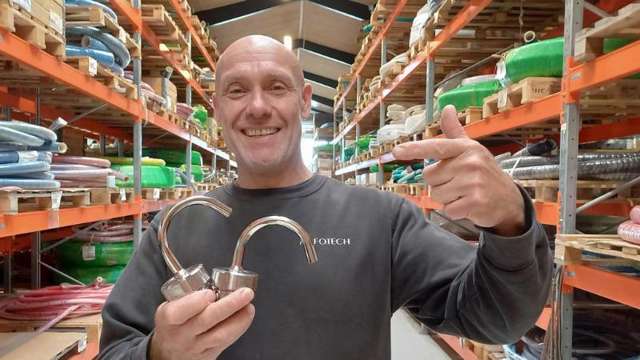 Warehouse worker holding two vent and exhaust valves