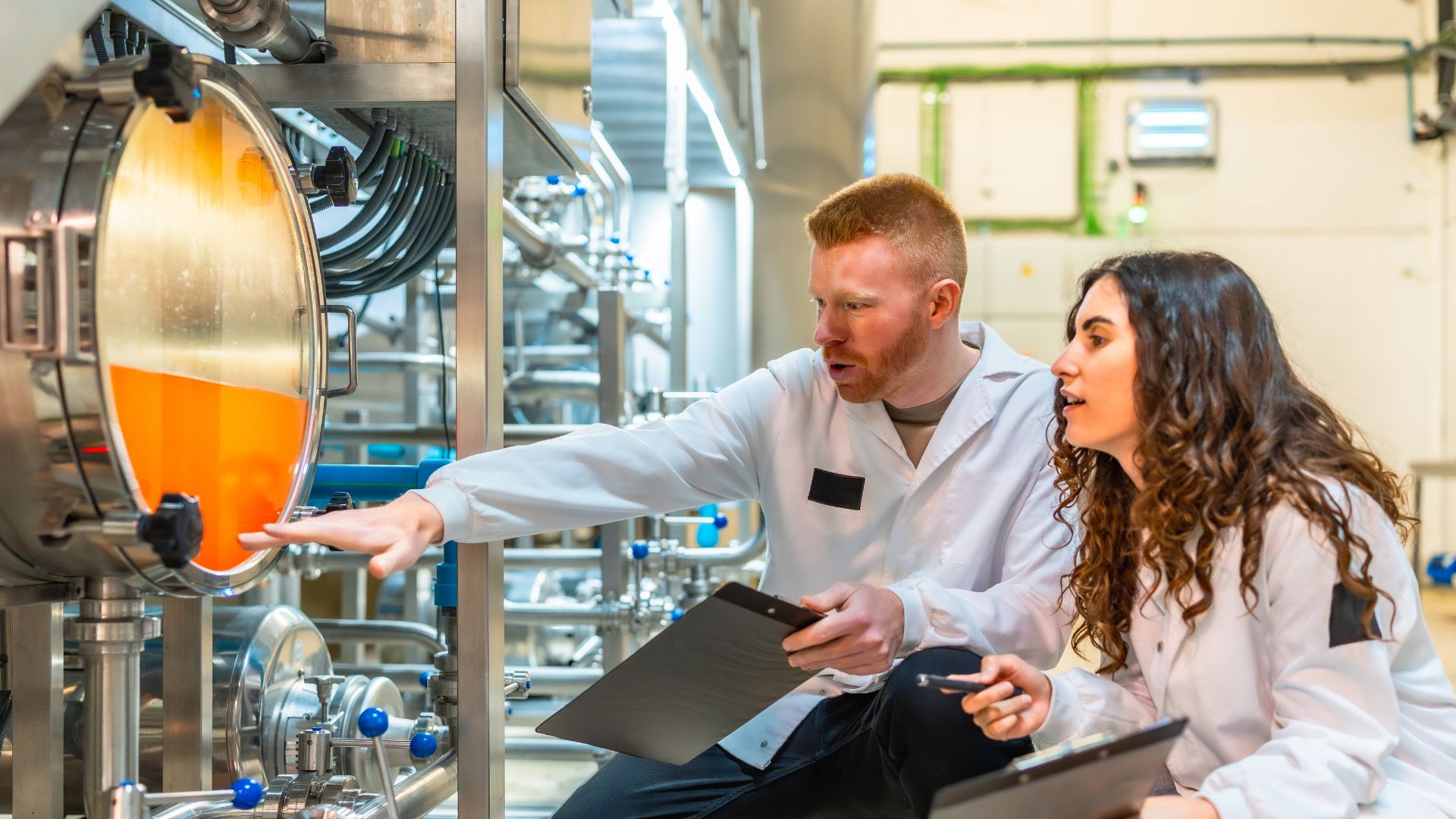 employees checking tank with juice