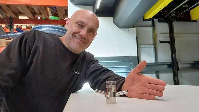 Warehouse worker shows sampling valve
