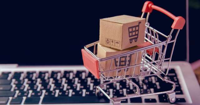 Miniature shopping cart on keyboard