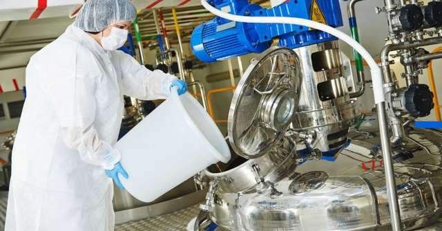 Service technician pours something into tank