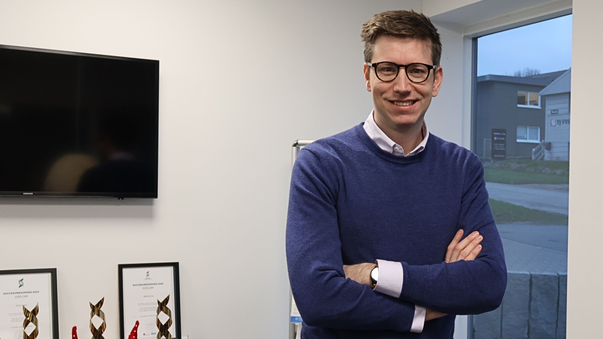 MAH standing in front of window